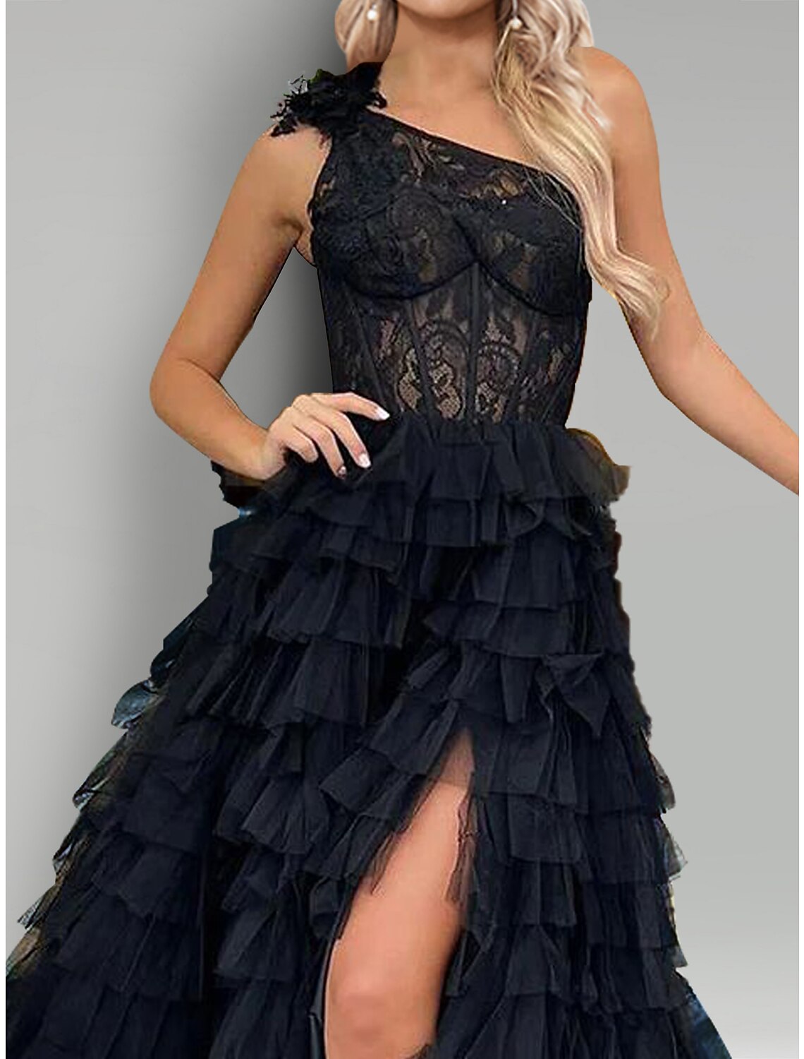 Close-up of lace appliques and slit detail on the A-line evening gown.