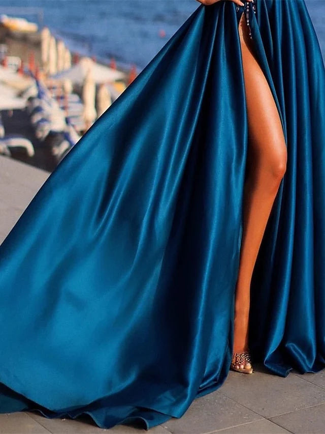 Close-up of the one-shoulder detail on a long A-line formal dress.