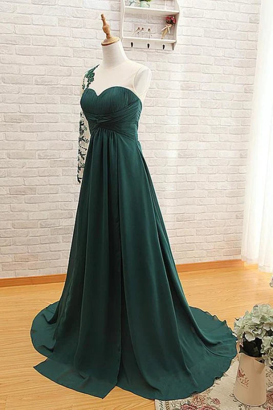 Side profile of the elegant one-shoulder long sleeve gown.