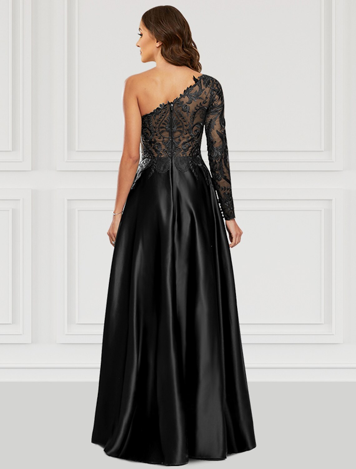 Back view of a model in an A-line one-shoulder long sleeve satin gown.