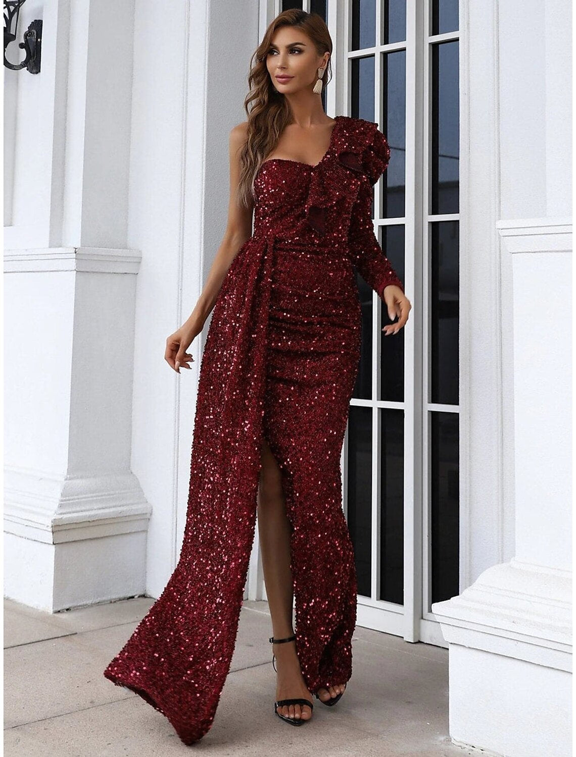 Model wearing the one-shoulder long sleeve sequined gown.
