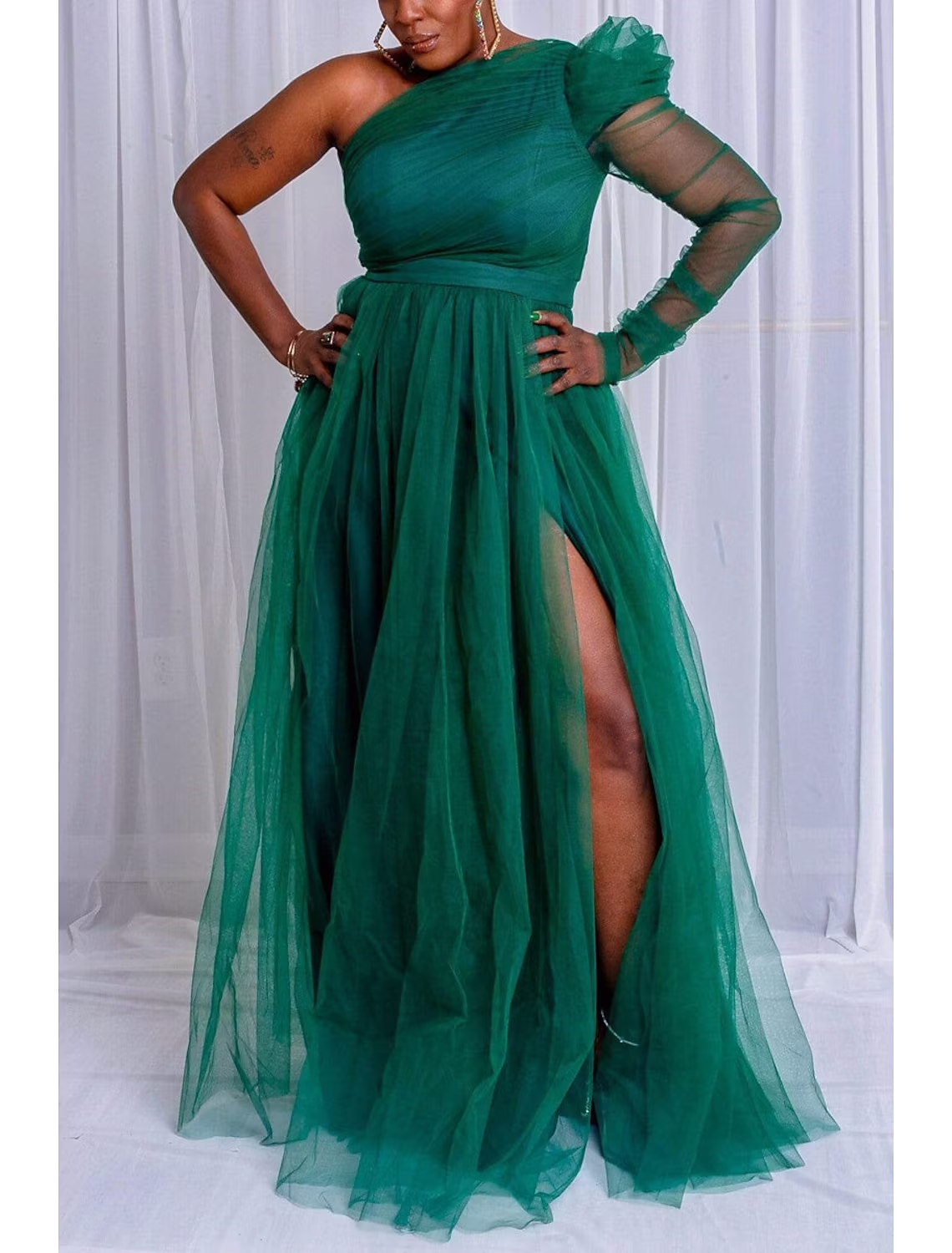 Back view of a plus size A-line one-shoulder long sleeve formal gown with a sweep train.