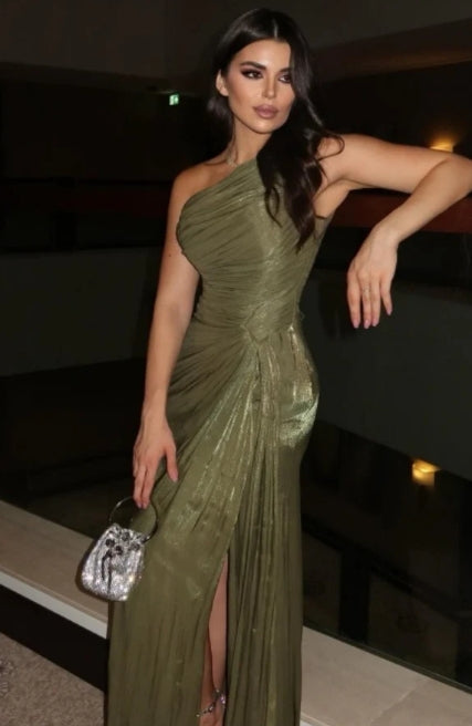 Model wearing an elegant one-shoulder pleated tulle prom dress with a high side slit and flowing train.