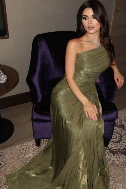Model posing in a one-shoulder A-line evening gown, showcasing the pleated bodice and flowing skirt.