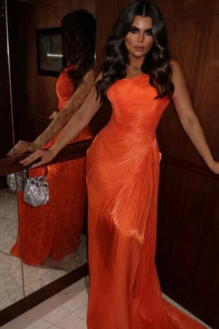 Model in a one-shoulder sleeveless dress, showing the high slit and movement of the tulle fabric.