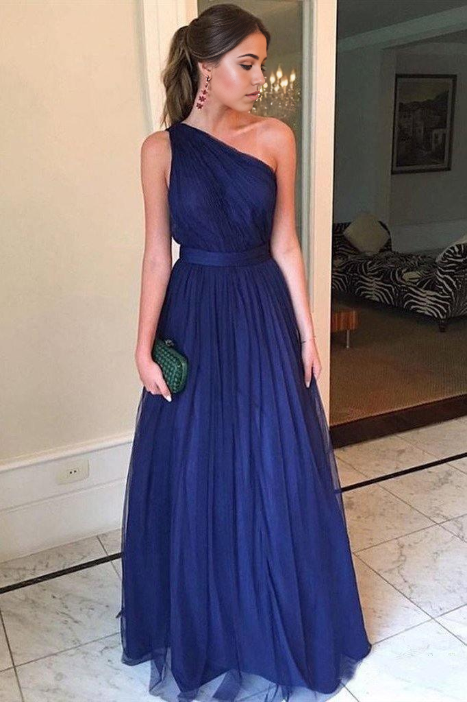 Model wearing a royal blue one-shoulder tulle long prom dress.