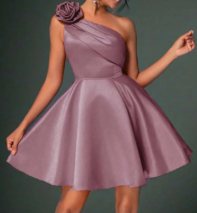 Side view of a woman in a floral one-shoulder satin homecoming dress.