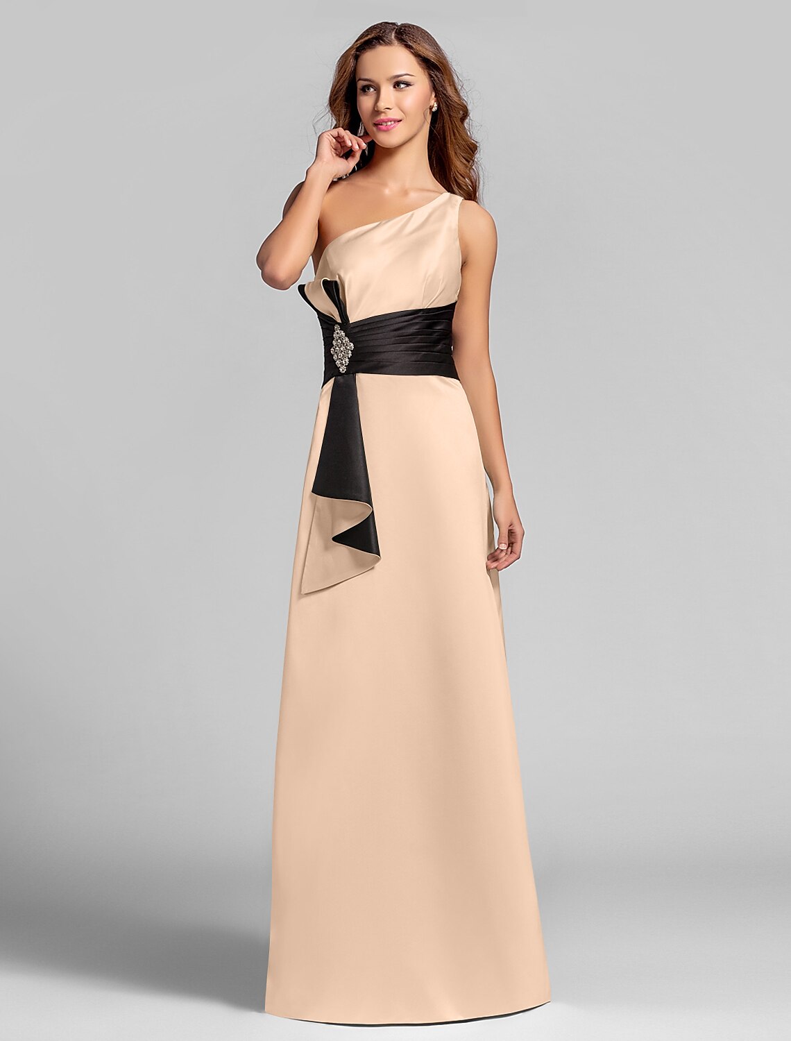 Side view of one-shoulder satin gown with crystal brooch detail.