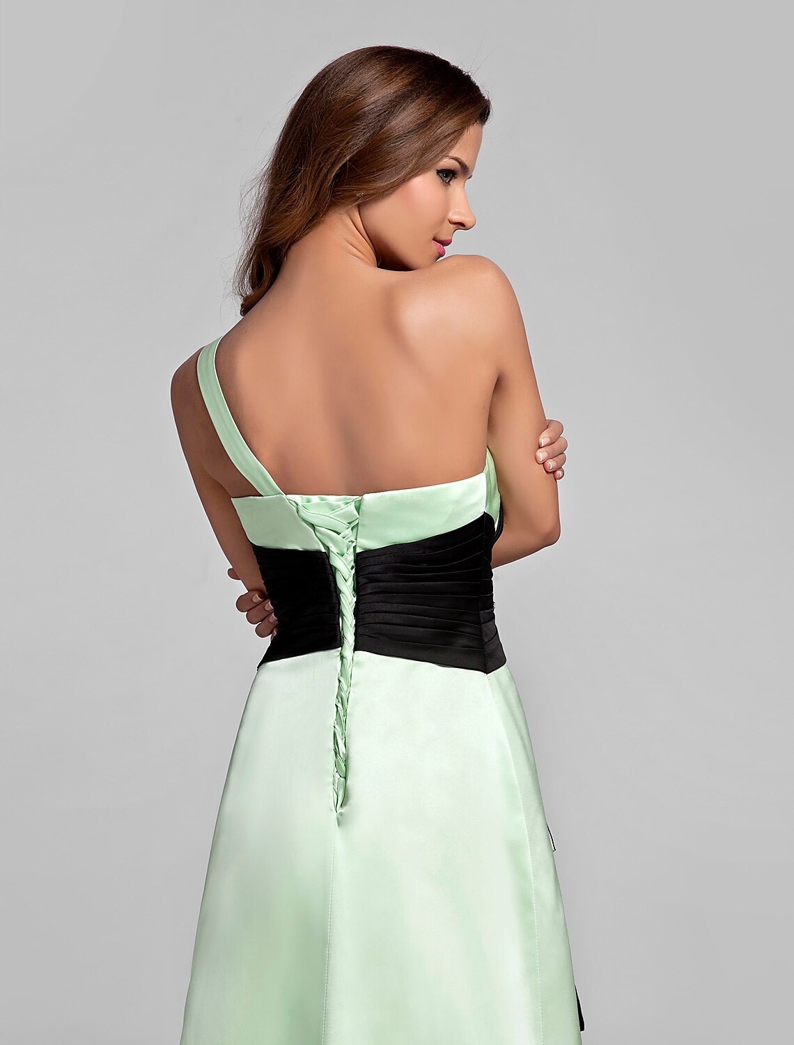 Detail of the floor-length skirt of the satin bridesmaid dress.