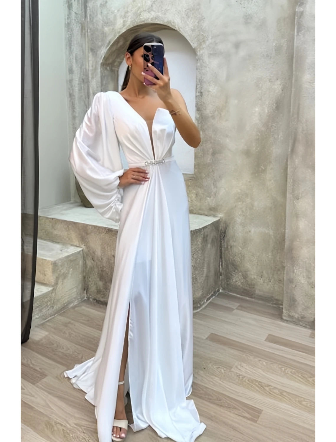 Back view of a woman in a formal satin evening dress.