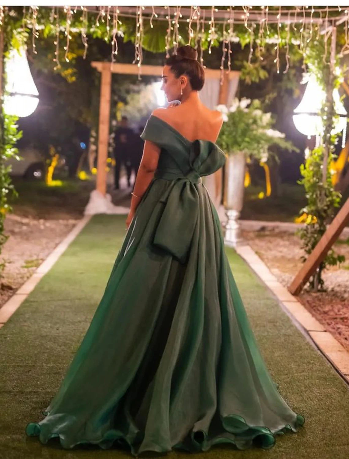 Side view of the A-Line gown, showcasing the one-shoulder design and flowing silhouette.