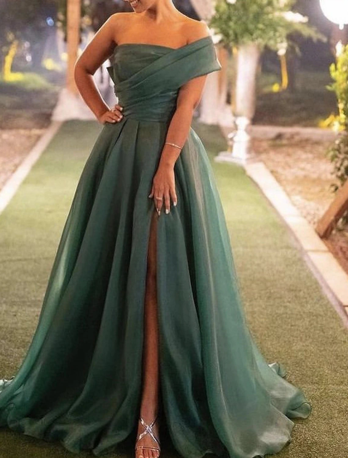 Close-up of the delicate organza fabric and ruched slit detail on the gown.