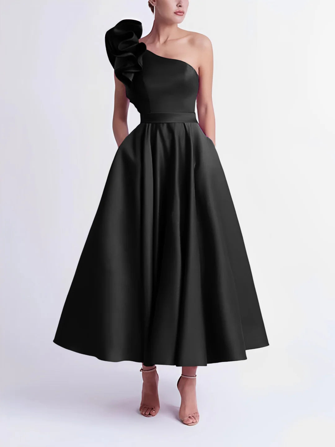 Model in a black A-line one-shoulder tea-length evening gown.