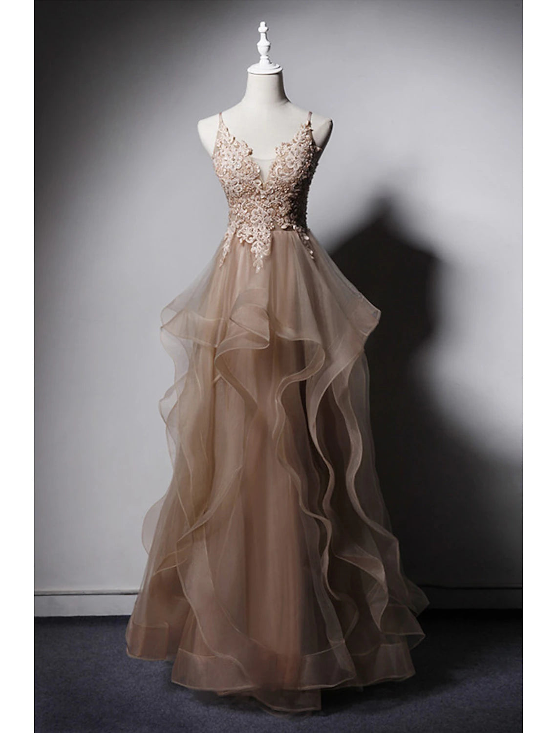 Elegant A-Line prom dress with spaghetti straps and open back.