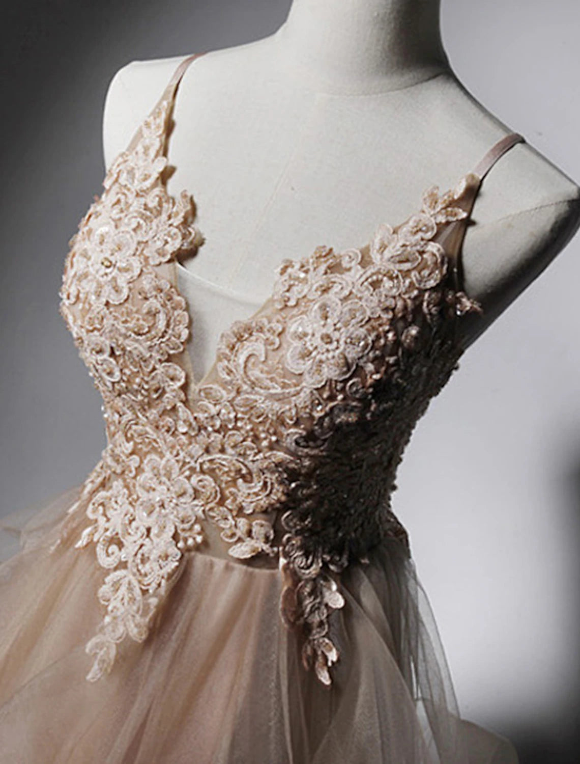 Back view of A-Line prom dress showing open back and spaghetti straps.