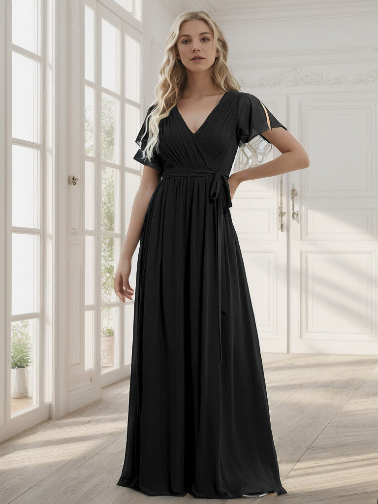 Close-up of the pleated detail on the black chiffon dress.