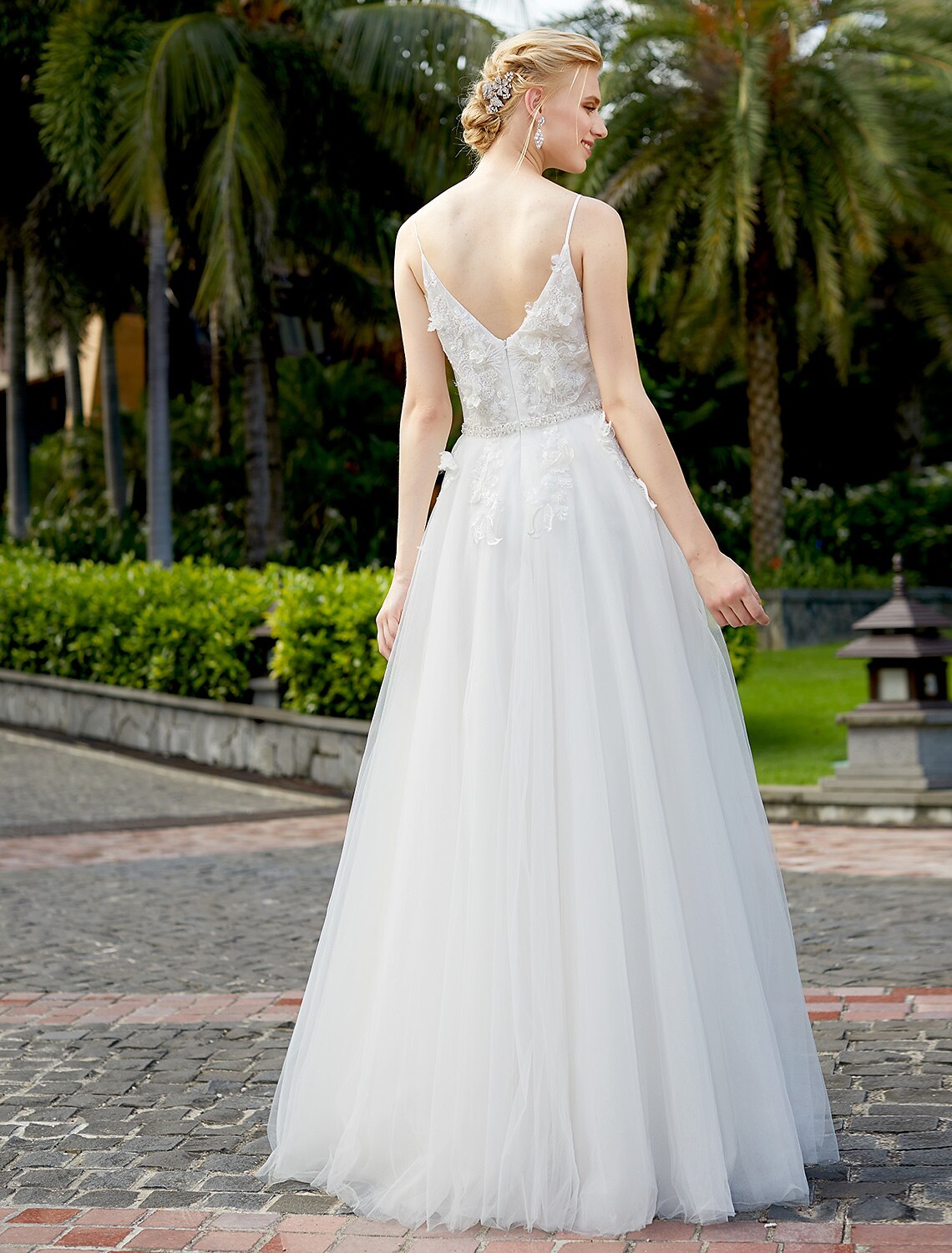 Elegant A-line wedding dress with plunging neck and tulle lace overlay.