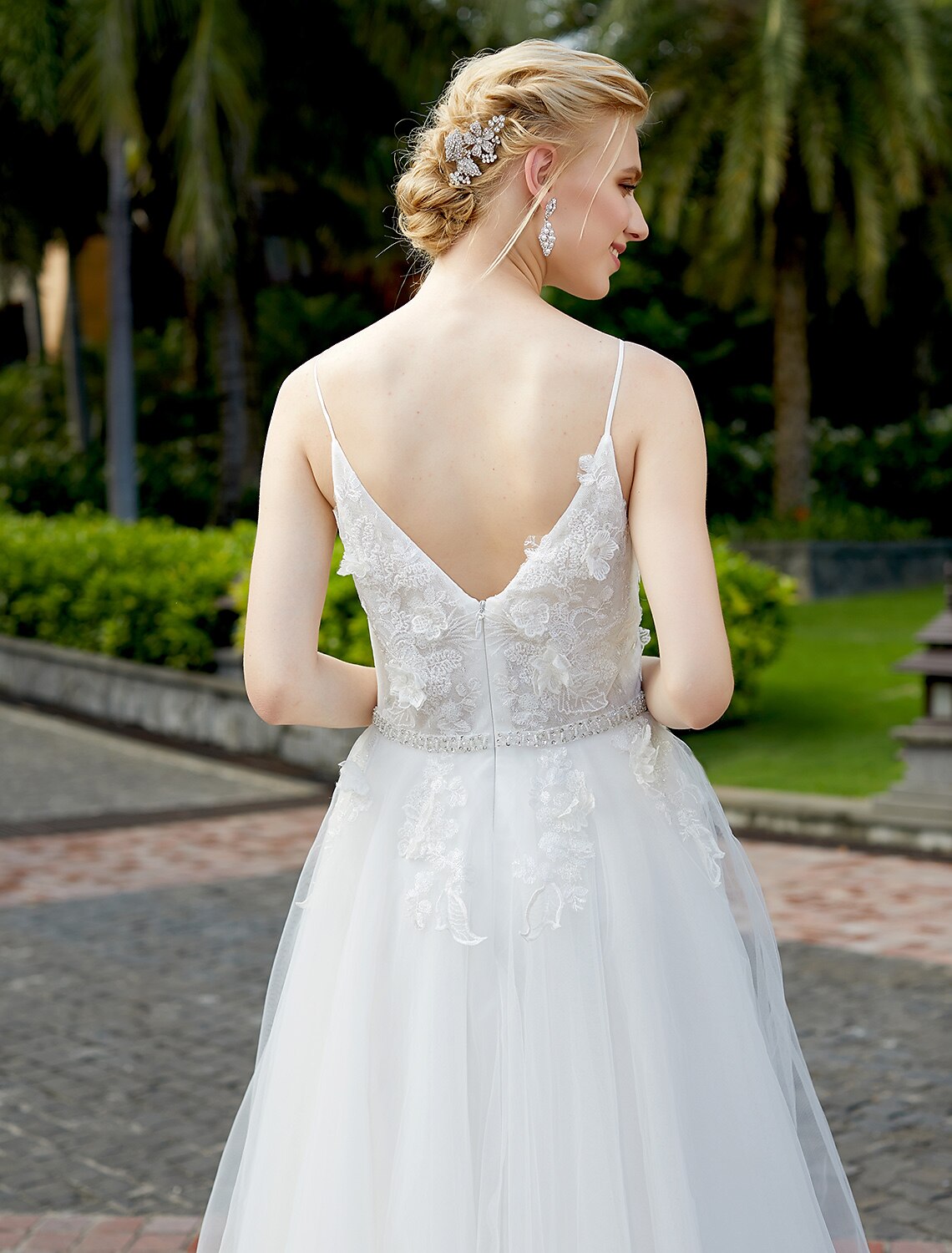 Elegant A-line wedding dress with plunging neck and tulle lace overlay.