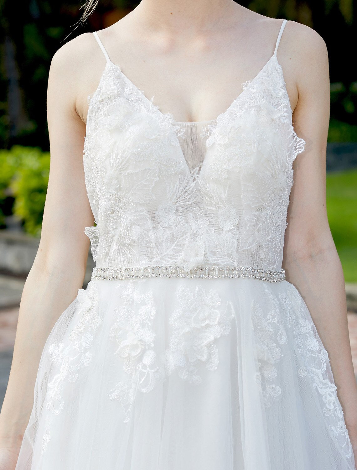 Elegant A-line wedding dress with plunging neck and tulle lace overlay.