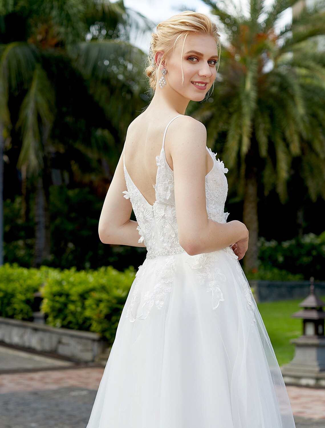 Elegant A-line wedding dress with plunging neck and tulle lace overlay.