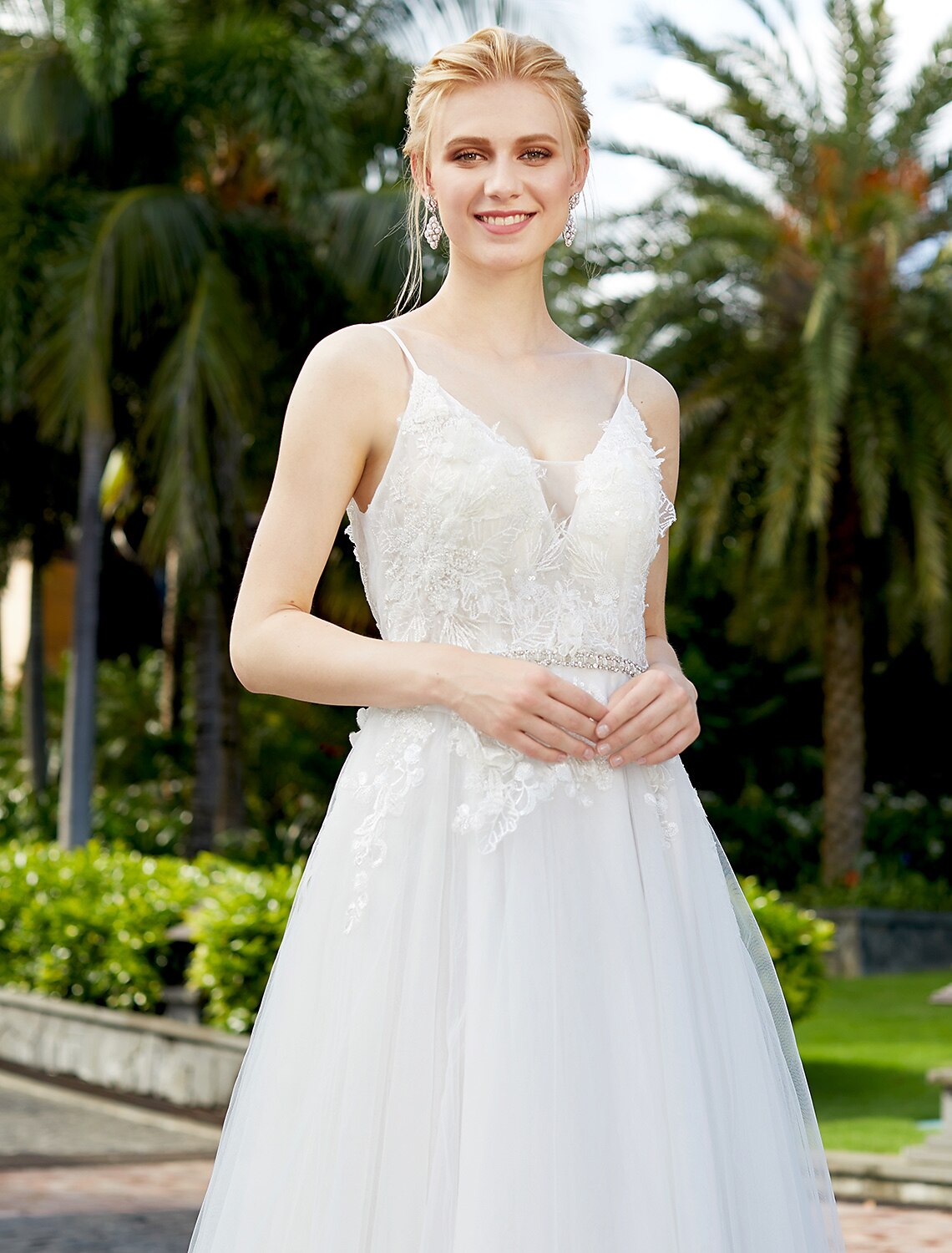 Elegant A-line wedding dress with plunging neck and tulle lace overlay.