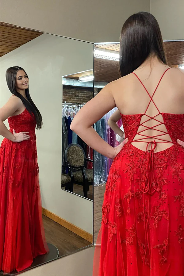 Long prom dress with floral appliques and a flowing skirt.