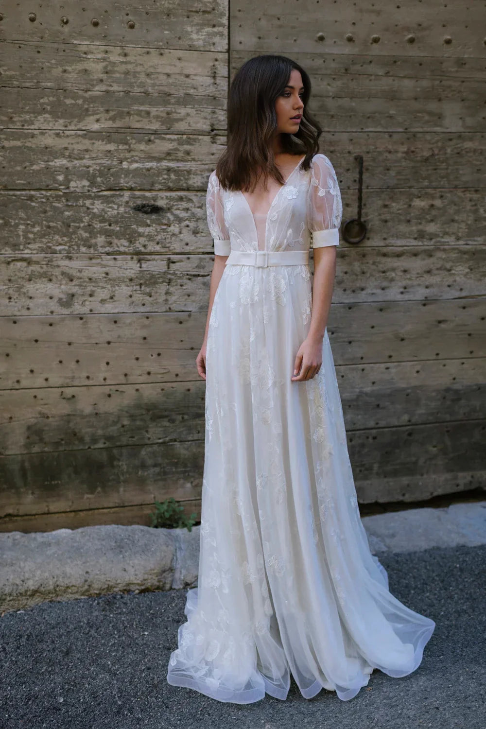 Elegant A-line tulle wedding gown with plunging V-neck and half sleeves.