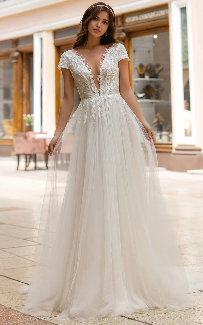 Elegant A-line wedding dress with plunging V-neckline and delicate appliques.