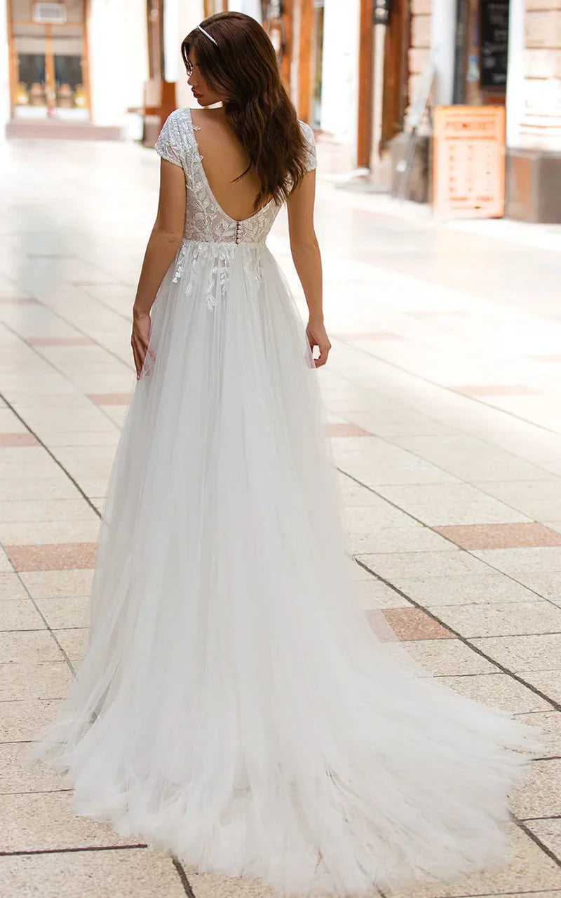Side view of the A-line tulle wedding dress featuring a sweep train.