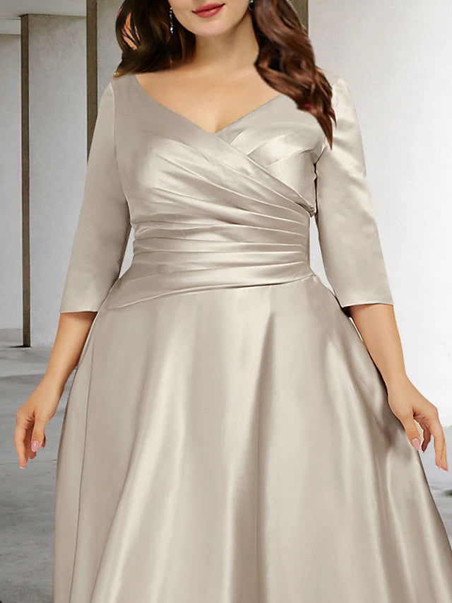 Side view of an elegant A-line plus size V-neck ruched satin tea length dress.