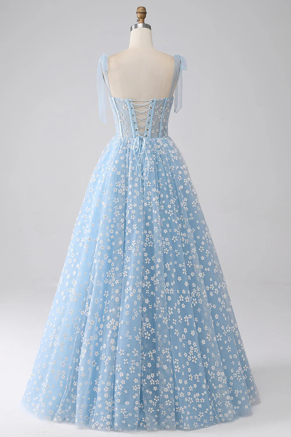 Back view of the A-Line print pleated tiered prom dress showing corset detail.