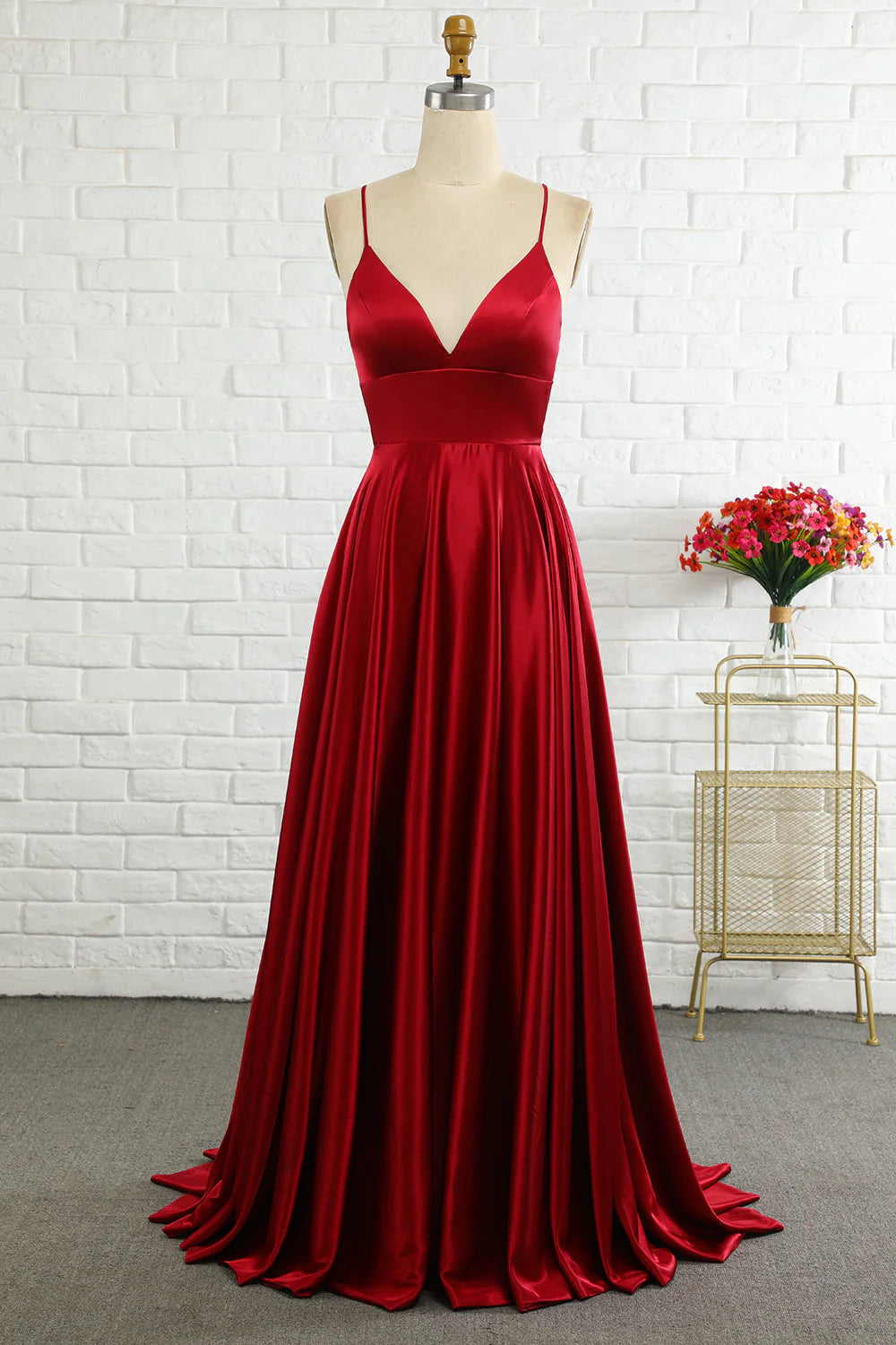 Elegant A-line prom dress with spaghetti cross-back straps, front view.