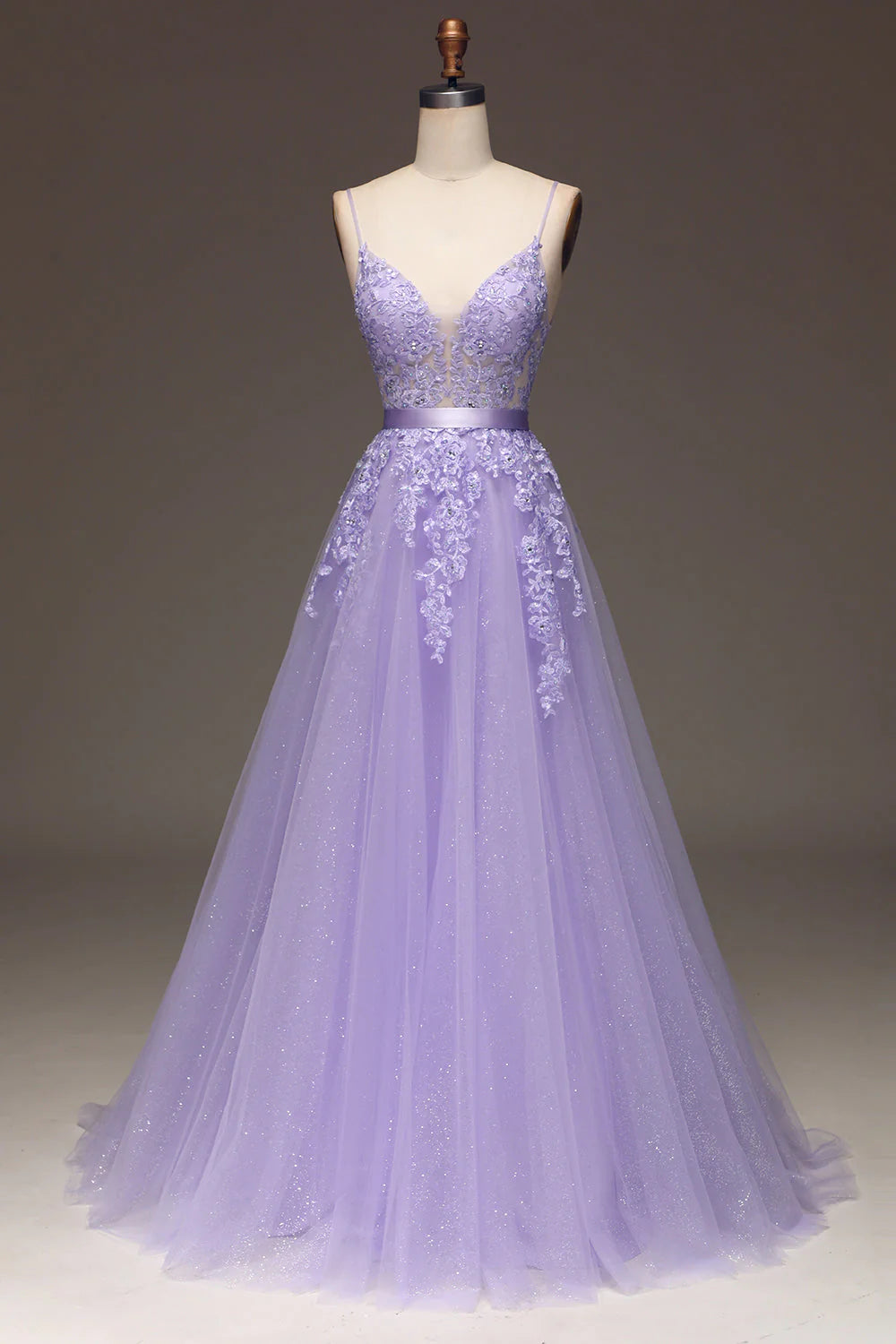 A-line purple prom dress with spaghetti straps, beading, and tulle appliques.