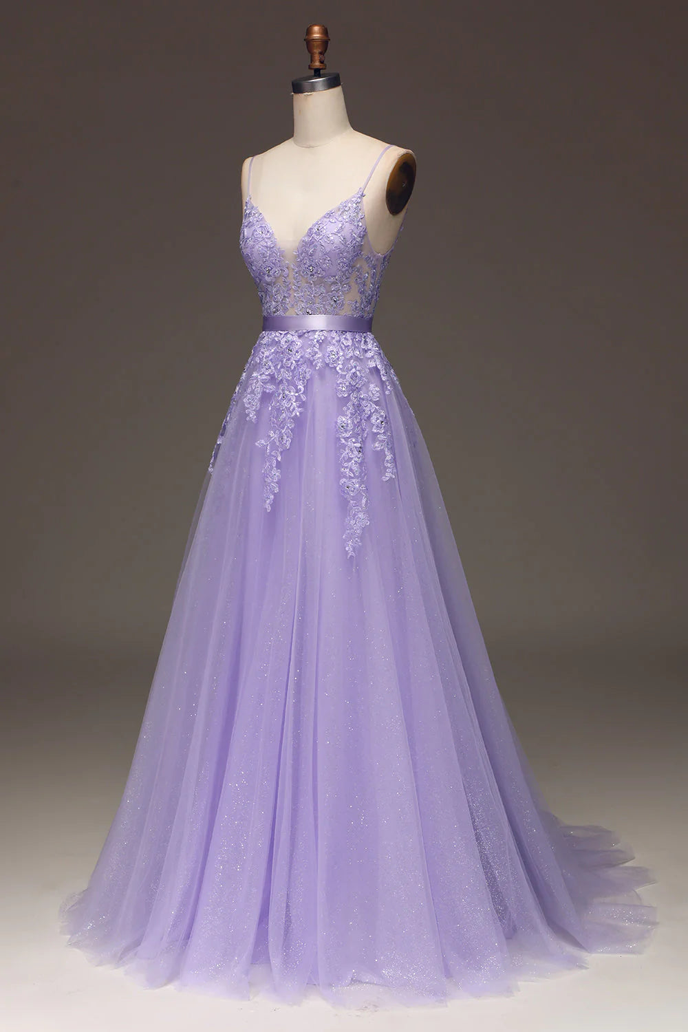 Close-up of the beaded bodice and tulle appliques on the purple prom dress.