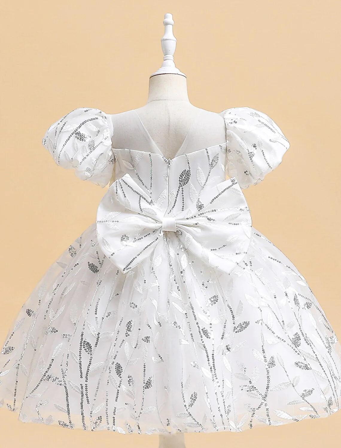 Side view of an elegant white embroidered A-line dress for girls.