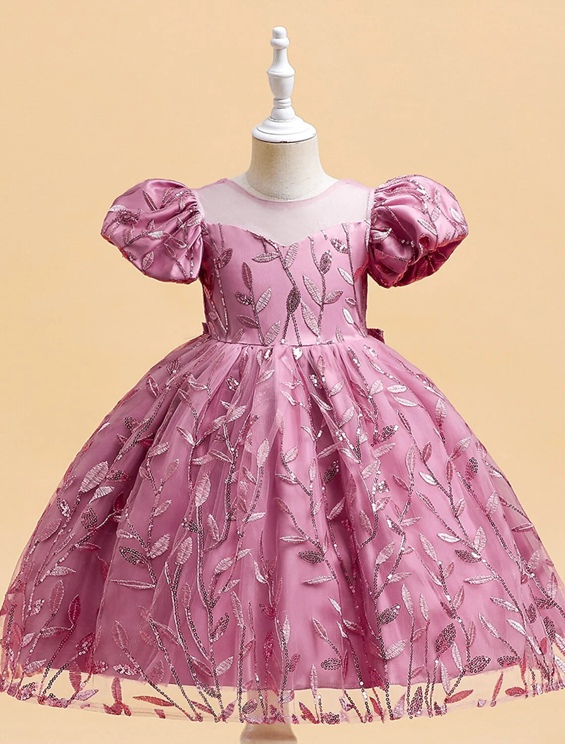 Back view of the white formal dress, highlighting delicate embroidery.