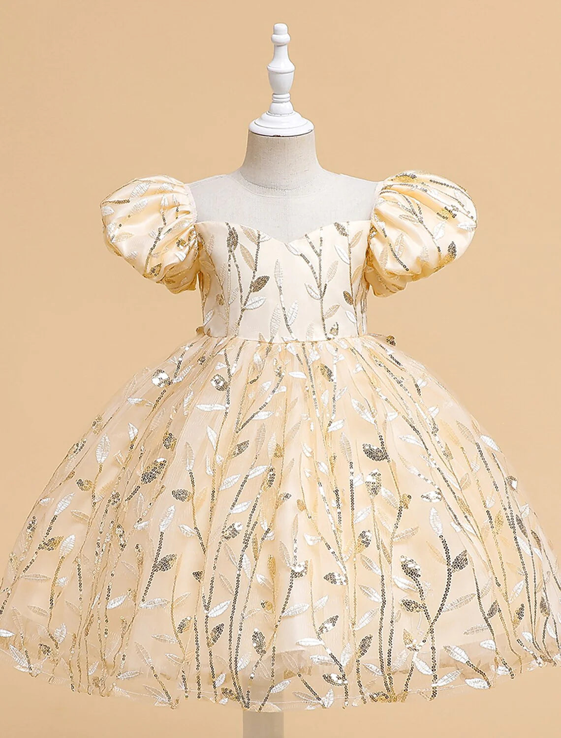 Young girl gracefully posing in the white knee-length communion dress.
