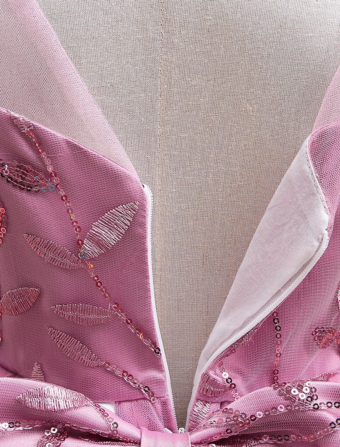 Detail of the knee-length skirt and fabric of the white prom dress.