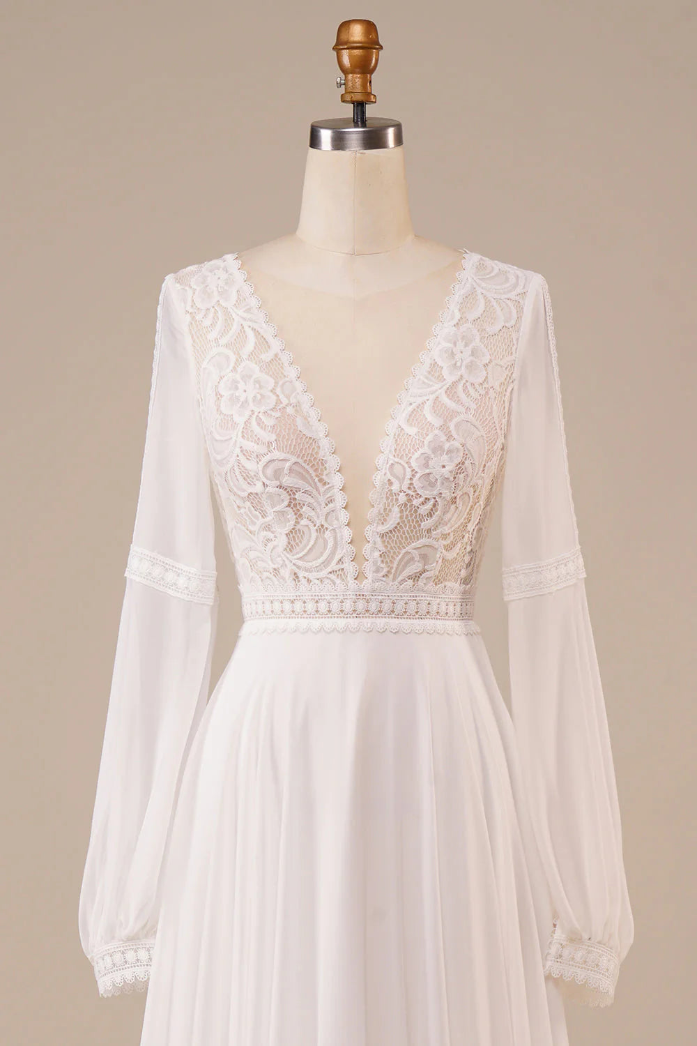 Back view of the ivory lace wedding dress with a flowing A-line skirt.