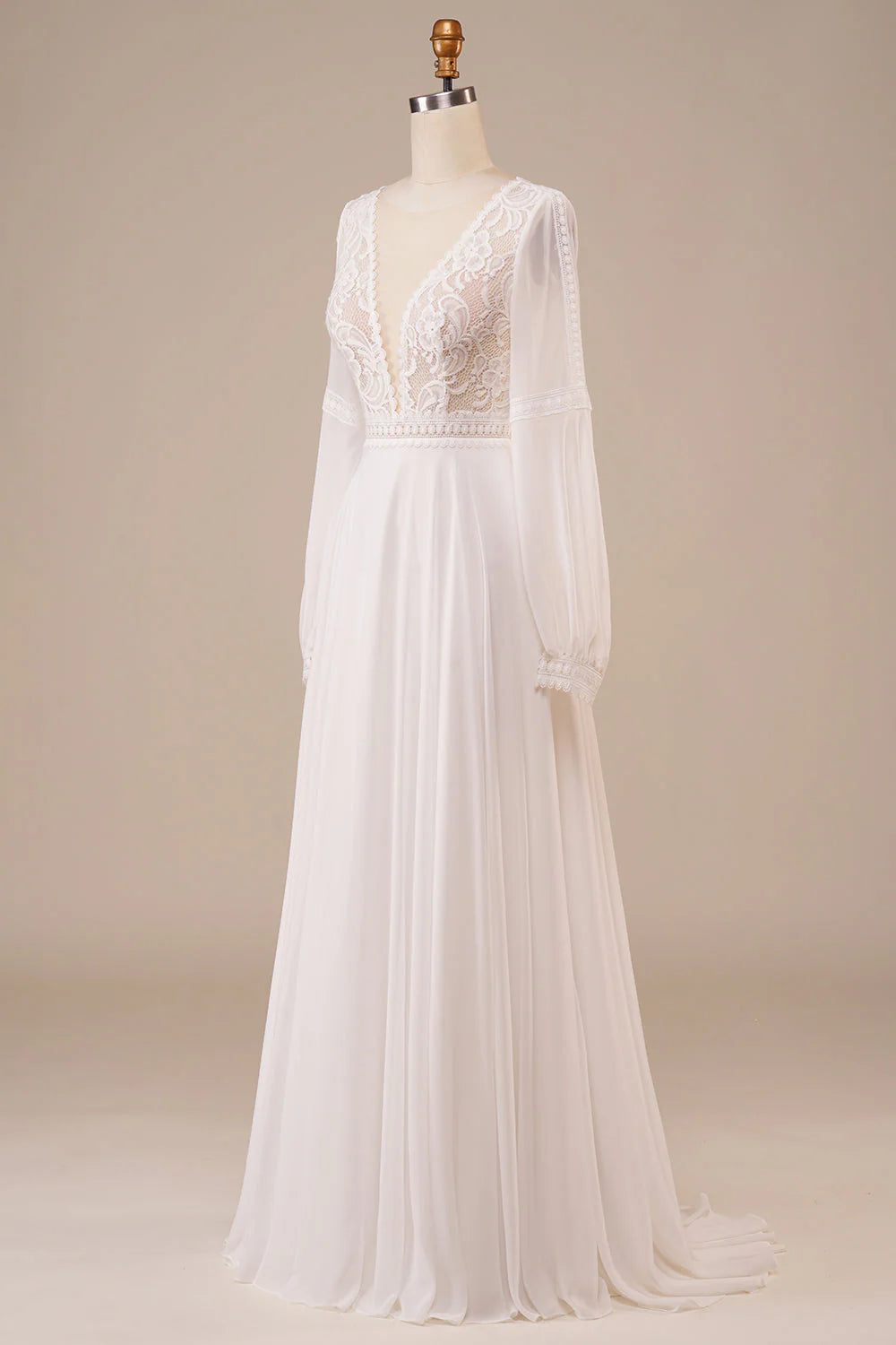 Bride wearing a romantic ivory long sleeve wedding dress with delicate lace.