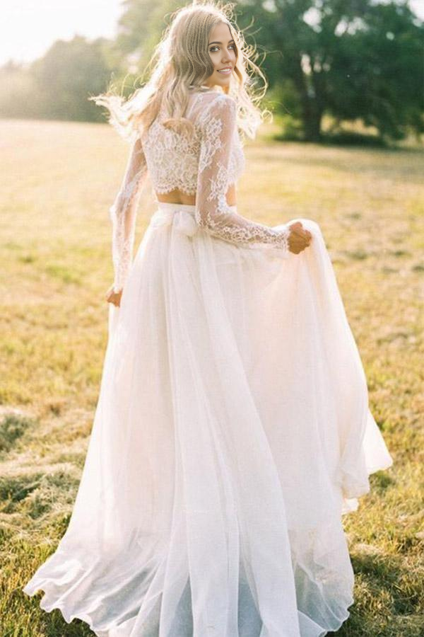 Front view of an elegant two-piece A-line lace wedding dress with long sleeves and a round neck.