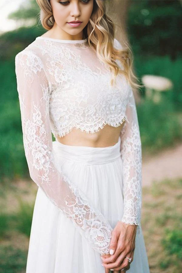 Side profile of the two-piece lace wedding dress, highlighting the intricate lace sleeves and flowing skirt.