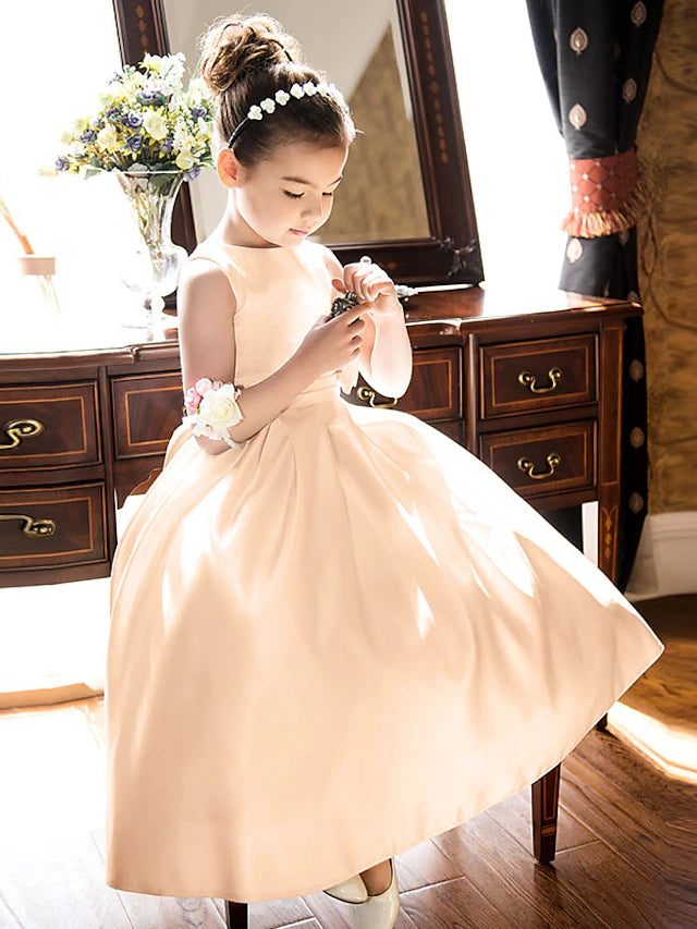 Back view of an A-line satin dress with a large bow for girls.