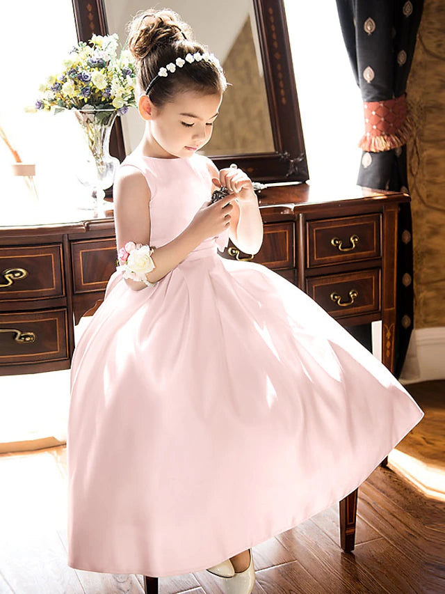 Side view of a girl in an ankle-length satin dress.