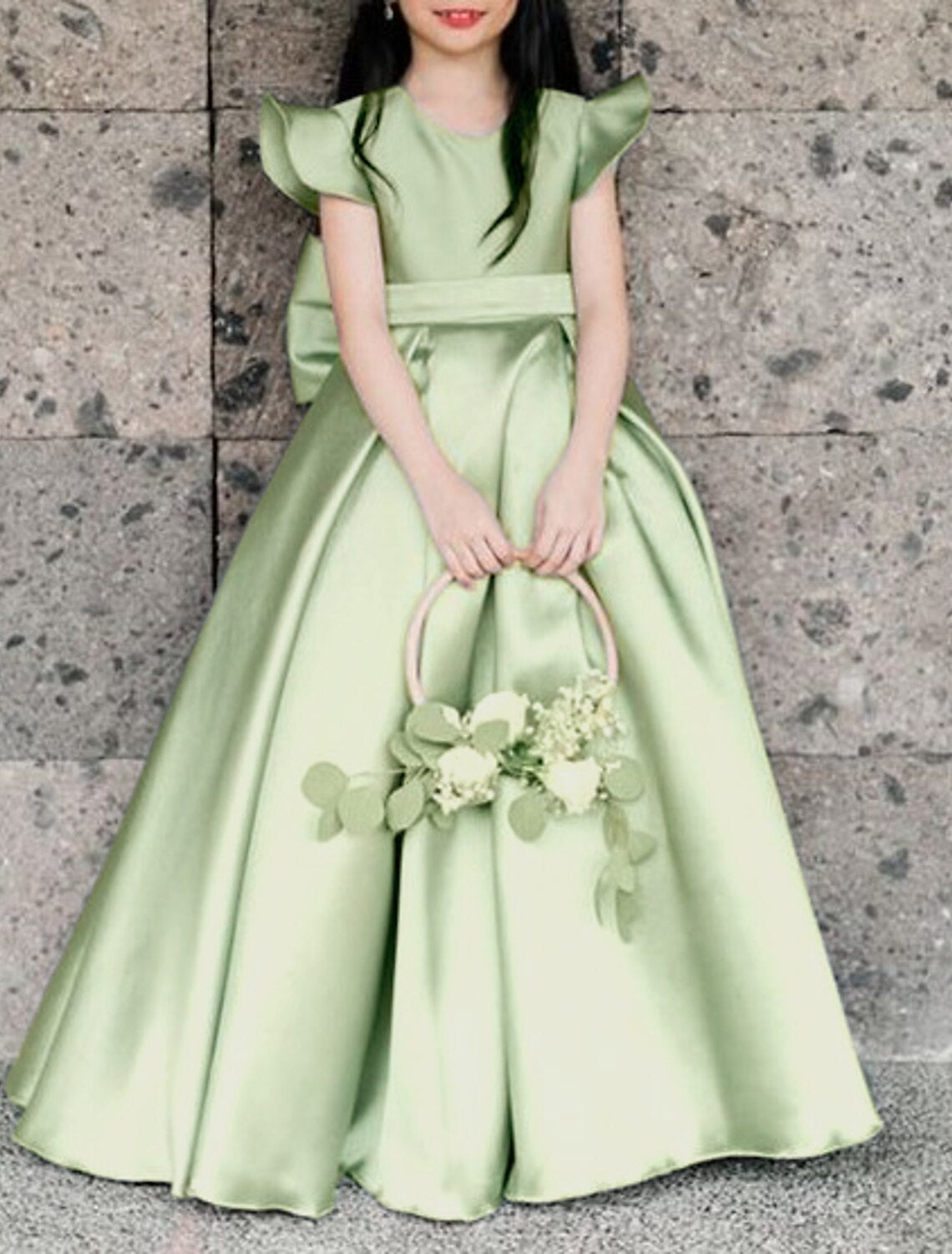 White A-line floor-length flower girl dress with a large bow on the back.