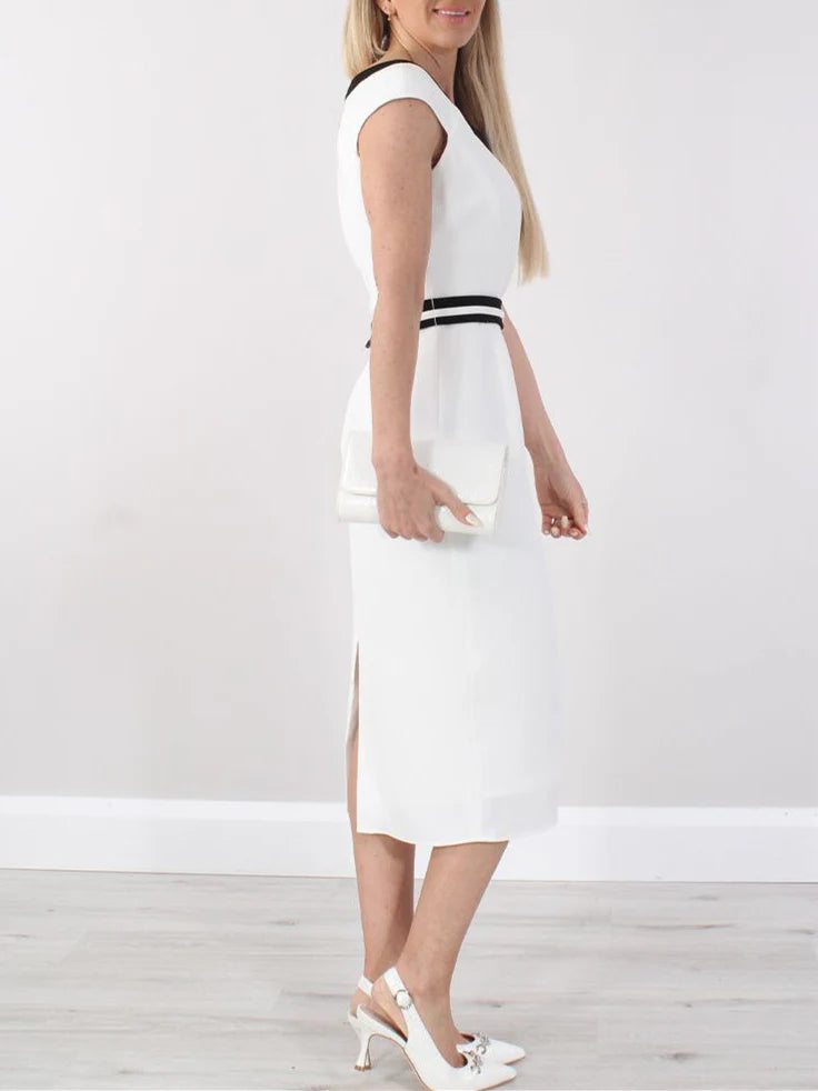 Close-up of the elegant A-line tea length dress, highlighting the round neckline and fabric detail.