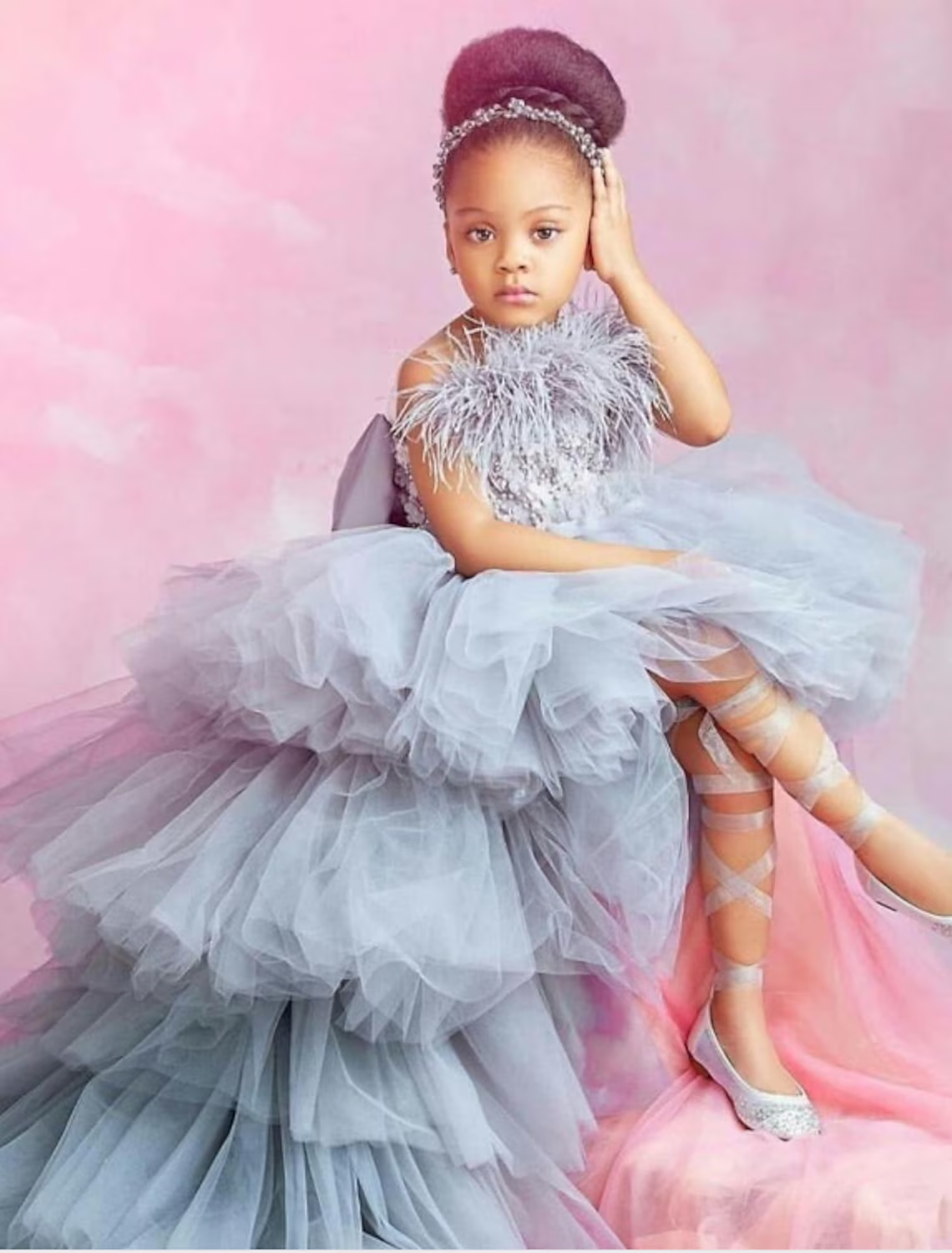Elegant A-line flower girl dress with chapel train and tiered skirt, adorned with feather details.