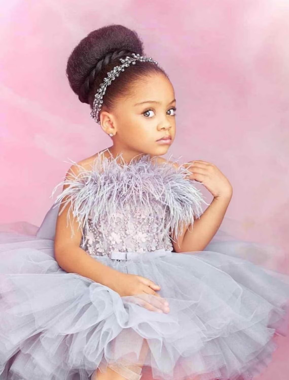 Back view of the A-line flower girl dress, showcasing the chapel train and tiered design.