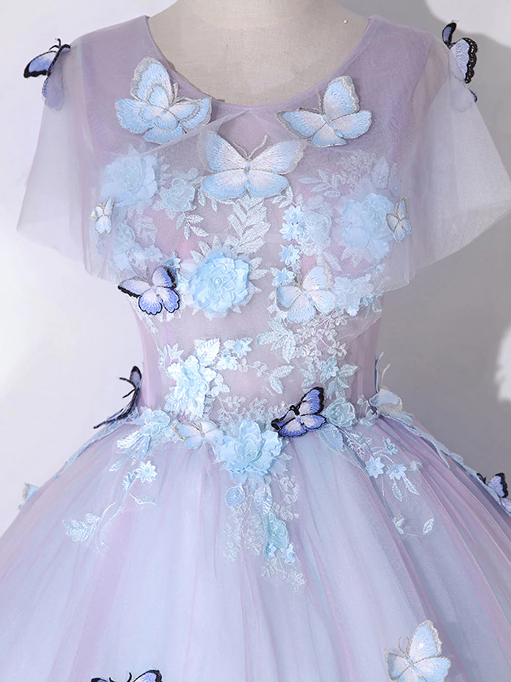 Close-up of the round neckline and bodice of an A-line tulle dress, highlighting the fabric texture.