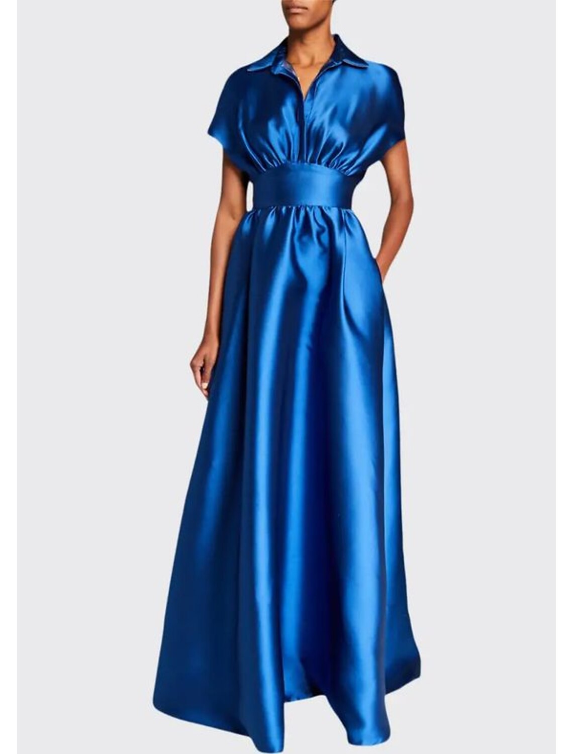 Close-up of the luxurious satin fabric and delicate pleats on the evening gown.